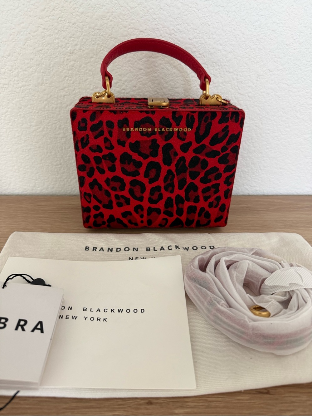 Brandon Blackwood Red and Black Leopard-Print Kendrick Trunk with Gold Hardware.